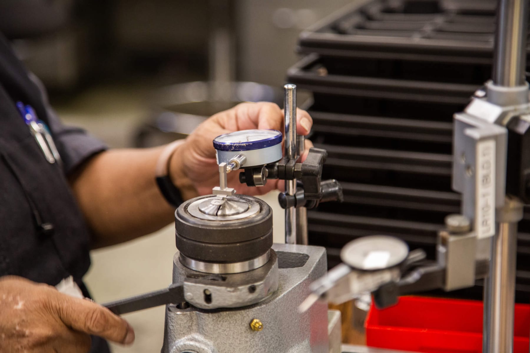 Technician measuring a machined assembly